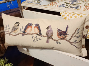 All the birds showed up to visit your home on one pillow!  We've got a chickadee, two bluebirds, a titmouse, and wrenny, all on a branch waiting to greet you every time you pass this adorable pillow! We especially love the detail of three wooden buttons on the end of this pillow. The birds are printed on a muslin fabric. The back side of the pillow has a cream-striped ticking fabric on it.  10" H x 24" W  Cotton, Poly Fiber