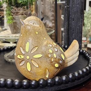 This bird figurine will put a BRIGHT spot in your home! This bird is looking up and has flower cut-outs on its chest and back with several oval cut-outs on its wings to let the LED light inside out to shed some light on your decor!  You'll love this so much, you'll want both styles!  6" H x 7" W x 4.5" D  Polyresin, Stone Powder  Requires 3 AAA Batteries
