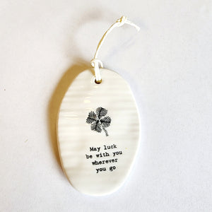 <p><span data-mce-fragment="1">This oval-shaped porcelain ornament is perfect to give to someone to let them know you are thinking of them! There is a four-leaf clover on the ornament with the words "May luck be with you wherever you go" written below.</span></p> <p><span data-mce-fragment="1">2 1/4" W x 3 1/4" H</span></p>