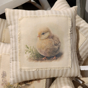 <p>This beautiful neutral pillow will fit in with any spring decor! A sweet little yellow chick sits by some greenery with little white flowers. The image is printed on cream fabric that has been fringed and then attached to a taupe ticking stripe fabric pillow.<br></p> <p>Approximately 8<span data-mce-fragment="1">"W&nbsp; X&nbsp; 8"H</span></p>