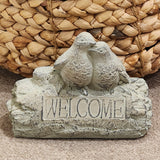 <p>This little welcome sign will greet guests entering your yard, garden, or home! Two weathered blue/green birds sit on a log with the word "welcome" etched into it.<span></span></p> <p>Approximately 8.5" W x 6.25" H x 4" D</p>