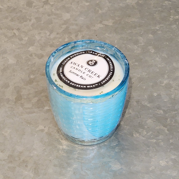 You'll love our newest candle style and size! This summer rain candle has been poured into a pretty basketweave-patterned bright blue glass.