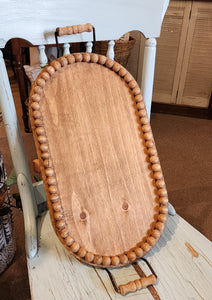 <p><span data-mce-fragment="1">Oh, the possibilities! This oval wooden beaded tray makes a lovely accent on any table. Fill it with collections, fun treasures, or seasonal decor. We love that you can lift it all up and out of the way if you need to ~ making it a must-need accessory for your home!</span></p> <p><span>2.75" H x 19" H x 10" D (width includes handles)</span></p> <p><span>Wood, metal</span></p>