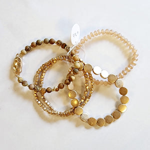 You'll love this five-piece stretch Boho Beaded Bracelet Stack! It consists of a semi-precious metal jasper glass beaded bracelet, a jasper bracelet with a golden nugget centerpiece, a golden nugget flat beaded bracelet, and two golden nugget bracelets. It's perfect for any season and great to combine with other bracelets for a thicker bracelet stack!  One size fits most.  Metal, glass, and natural Jasper stone beads and golden beads.