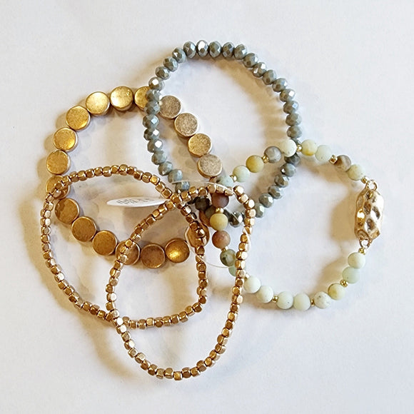 You'll love this five-piece stretch Boho Beaded Bracelet Stack! It consists of a semi-precious metal and amazonite glass beaded bracelet, an amazonite bracelet with a golden nugget centerpiece, a golden nugget flat beaded bracelet, and two golden nugget bracelets. It's perfect for any season and great to combine with other bracelets for a thicker bracelet stack!  One size fits most.  Metal, glass, and natural Amazonite stone beads as well as gold beads