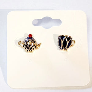 Wear this elegant navy blue and gold teapot and teacup post earrings to your next tea party! Both whimsical and charming, these mismatched pair of gold earrings feature a navy blue enamel teapot and teacup. The intricate detailing and sophisticated color create a playful and eye-catching look.  Made in China  Measures: 3/8 x 3/8"  Materials: Gold Tone Metal, Enamel