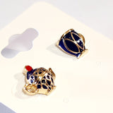 Wear this elegant navy blue and gold teapot and teacup post earrings to your next tea party! Both whimsical and charming, these mismatched pair of gold earrings feature a navy blue enamel teapot and teacup. The intricate detailing and sophisticated color create a playful and eye-catching look.  Made in China  Measures: 3/8 x 3/8"  Materials: Gold Tone Metal, Enamel