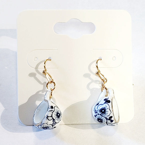 Care for a spot of tea? These adorable tiny teacup earrings are decorated with delicately drawn blue flowers and gold trimmed accents; these realistic-looking miniature teacup earrings are the perfect teatime accessory.  Made in Chin  Dimensions: 1