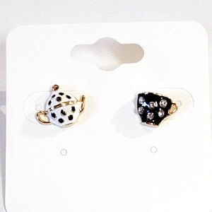 Care for a SPOT of tea?&nbsp; You'll get compliments on these playful black and white teapot and teacup post earrings. They are a whimsical and charming, mismatched pair that celebrates the joy of tea time. They feature a white with black polka dot teapot and a black rhinestone-covered teacup. The intricate detailing and contrasting colors create a playful and eye-catching look.