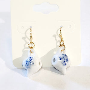 I'm a little teapot, a very little teapot! You won't be able to resist these adorable miniature ceramic teapot earrings. If you love a good cuppa, you'll love wearing these sweet blue and white teapot earrings.&nbsp;  Made in China  Genuine ceramic miniature teapot earrings  Measures: 1 3/8" x 5/8  Materials: Gold Tone Metal, Ceramic