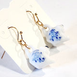 I'm a little teapot, a very little teapot! You won't be able to resist these adorable miniature ceramic teapot earrings. If you love a good cuppa, you'll love wearing these sweet blue and white teapot earrings.&nbsp;  Made in China  Genuine ceramic miniature teapot earrings  Measures: 1 3/8" x 5/8  Materials: Gold Tone Metal, Ceramic