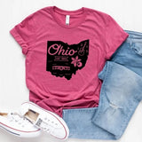 OH-IO! Oh, how we love our new state tee in a fun, bright raspberry color! In the center is a black silhouette of the state of Ohio with the word "Ohio" written on it and "EST. 1803" below it. The top right has a guitar for the Rock-n-Roll Hall of Fame, below it is a Buckeye and at the bottom is the Wright Flyer.