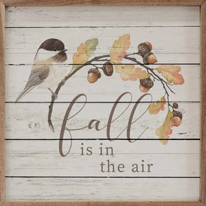 For our bird lovers, we have a little bird hanging on an oak leaf branch with acorns and the words "fall is in the air" in a mixed font down below!