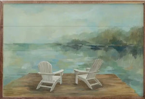 Get swept away for a relaxing day at the lake with this "Lakeside Retreat I" artwork by Silvia Vassileva! Two Adirondack chairs sit on the dock, ready for you to kick back and relax and let the stress melt away!   Made in the USA  24" x 16" x 1.5"  *This Artwork is oversized and will need to be picked up at the Helena, OH, location.