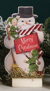 This vintage-inspired wooden snowman is holding a "Merry Christmas" sign and has one elf on his shoulder and one down below. This board looks cute mixed in with your other Christmas decor or standing alone!