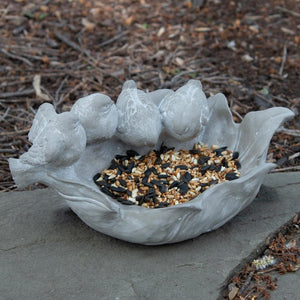 Bring a little whimsey to your garden this year with this sweet cement bird feeder that has four birds perched on the leaf.  5 H x 10 W x 6 D
