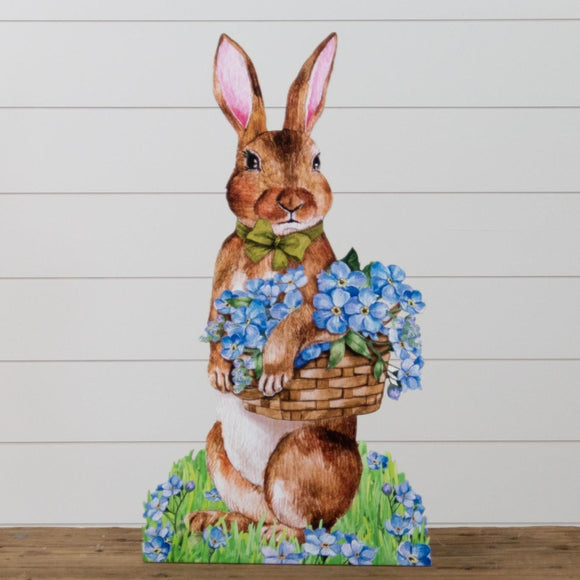 Celebrate spring with this adorable brown bunny holding a basket full of blue flowers. He will look too cute in the entryway or on a covered porch, ready to greet everyone!  MDF  28
