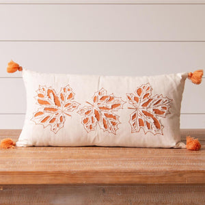 Get ready for fall with this beautiful cream pillow with orange embroidered cut-out leaves and orange fabric peeking through. There are pretty orange tassels on each of the four corners.  12" H x 24" W  Cotton, Polyester Fiber