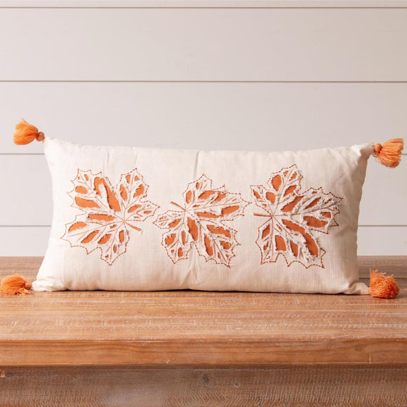 Get ready for fall with this beautiful cream pillow with orange embroidered cut-out leaves and orange fabric peeking through. There are pretty orange tassels on each of the four corners.  12