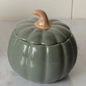 This beautiful ceramic pumpkin is a soft green and will be the star of the show in your fall decorating!  It has a removable lid with a stem as the handle, which makes it easy to get into. Use it as a candy dish or to hold little trinkets.  Food Safe. Hand Wash; Do not Microwave  5.12" H x 5" Dia