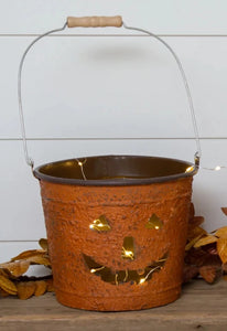 You'll smile every time you see this adorable smiling Jack-O-Lantern bucket! It has a handle on it so that you can hang or carry it with ease. Use it to hold your trick-or-treat candy, put a candle in it and use on your front porch or table! We also think it would be terribly cute with a mum in it!!  8.5" H x 10.5"