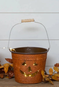 You'll smile every time you see a small adorable, smiling Jack-O-Lantern bucket! It has a handle so that you can easily hang or carry it. Use it to hold your trick-or-treat candy, put a candle in it and use it on your front porch or table! It would be terribly cute with a little mum in it!!  8.5" H x 10.5"