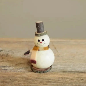This tiny little snowman is such a treat! He is the perfect unique gift or accessory for small spaces. This hand-painted white snowman is crafted from hard shell gourds by a small team of expert crafters and has amazing detail for such a tiny piece. He has a red nose, colorful scarf and a cute wooden hat and base. He is approximately 2 1/4" in diameter and 4" tall. Because this design is crafted using natural gourds, each piece is ever so slightly different to make for a unique artisan piece.