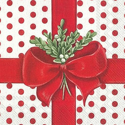 This sweet cocktail napkin looks like a present that needs to be opened! A white background with a red polka dot design on the paper is 