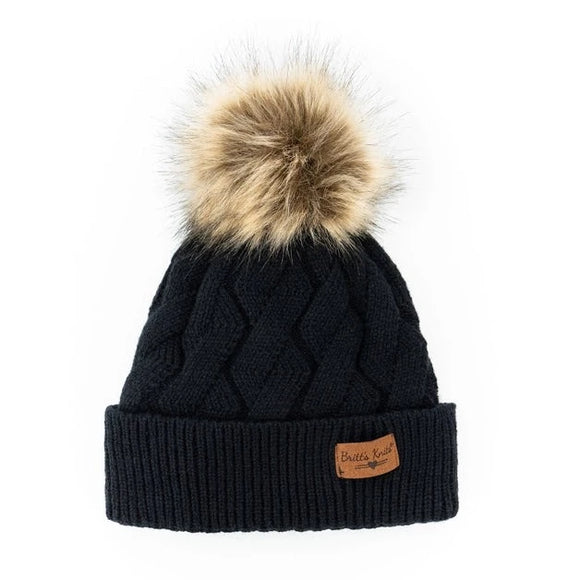 Stay warm and fashionable with our Britt Knits black cable knit hat with a tan and brown faux fur pom. The inside is ultra-cushy and velvety, so you'll never want to take it off!! It can be worn fitted or slouched with a subtle braided design to match any style coat, jacket, or tee.
