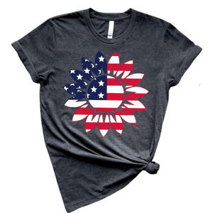 You'll want to wear this American Sunflower tee all summer long! This charcoal grey tee has one large sunflower shape on the front that has the Stars &amp; Stripes in Red, White &amp; Blue on it! The shirts are soft Bella and Canvas unisex fashion-fit tees that fit like a well-loved favorite, featuring a crew neck and short sleeves.

100% Airlume combed and ring-spun cotton.

Made in the United States