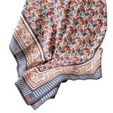 We are loving this tablecloth with mix of blues, reds and creams in stripes, paisley and floral patterns! 50" W x 60" L 