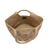 Beautiful hand painted daisies in shades of coral and pink adorn this oversized tote handcrafted from all natural jute fibers. The natural braided jute handles and built in shoulder strap make the Anya Tote easy to carry for carefree summer days.
Product Details
Dimensions: 12 in. H x 19 in. W x 11 in. D
Open topHandles: 4.5 in. drop
Shoulder straps: 10 in. drop
100% Natural Jute with hand painted daisy pattern
Unlined