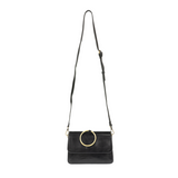Put a ring on it! Perfect for your next night out, this cute black bracelet bag looks great with your fav jeans or slinky dress! With multiple compartments, it is just the right size to hold all your essentials. Wear it on your wrist with the metallic ring bracelet, or carry as a clutch, or wear as a crossbody with the detachable shoulder strap.


Dimensions: 6 in. H x 8.25 in. W x 3.5 in. at deepest point
Tapers up to the top point
Adjustable and removable crossbody strap: 20-25 in.
3 in. diameter ring tha
