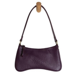 Meet Nicolette, our sleek, curvy aubergine colored crossbody pochette with a minimalist style. Featuring soft sculptural curves in tumbled vegan leather, this bag is closed with a brass zipper that encloses 3 interior compartments to keep your cards, cash, keys and phone stowed neatly. The gleaming brass rings open to swap out the two included shoulder straps. A short strap for dressier looks and a longer adjustable crossbody strap when you want to go hands free. Available in an array of beautiful colors, t