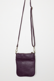 This aubergine colored compact phone bag is designed for everyday convenience and hands-free style. This slim crossbody is made from softly tumbled vegan leather with a sleek silhouette, adjustable crossbody strap and a secure zip closure. The Lia features a front zip pocket and a back slide pocket to keep your phone, cards, keys and small essentials neatly organized and easy to access. This crossbody bag is perfect for travel, shopping, concerts or daily errands.
Product Details
Dimensions: 7.5 in. H x 6.2