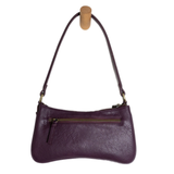 Meet Nicolette, our sleek, curvy aubergine colored crossbody pochette with a minimalist style. Featuring soft sculptural curves in tumbled vegan leather, this bag is closed with a brass zipper that encloses 3 interior compartments to keep your cards, cash, keys and phone stowed neatly. The gleaming brass rings open to swap out the two included shoulder straps. A short strap for dressier looks and a longer adjustable crossbody strap when you want to go hands free. Available in an array of beautiful colors, t