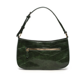 The sleek bottle green Erin Hobo will compliment your look for the office or your next night out. Fashioned in glossy croc embossed vegan leather, this sophisticated bag closes with a brass zipper to keep your belongings secure and is accented with burnished brass rings that open to allow you to change the shoulder straps. Two shoulder straps are included with this stylish Hobo, a short strap to carry close to the body or a long strap to carry as a shoulder bag or as a crossbody. Both straps are adjustable 