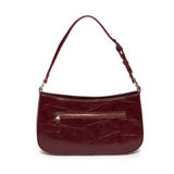 The sleek burgundy Erin Hobo will compliment your look for the office or your next night out. Fashioned in glossy croc embossed vegan leather, this sophisticated bag closes with a brass zipper to keep your belongings secure and is accented with burnished brass rings that open to allow you to change the shoulder straps. Two shoulder straps are included with this stylish Hobo, a short strap to carry close to the body or a long strap to carry as a shoulder bag or as a crossbody. Both straps are adjustable and 