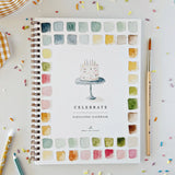 An invitation to slow down and paint something pretty. The Celebrate Watercolor Workbook features twelve party illustrations — balloons, a wrapped gift, a confetti birthday cake, a pup in a party hat, and more — each outlined and ready to paint. Simple step-by-step instructions walk you through every illustration, and most paintings take about thirty minutes from start to finish — so even if you've never painted before, you'll have something lovely in your hands by the end. A sweet birthday gift, or an easy