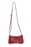 Meet Nicolette, our sleek, curvy chilli colored crossbody pochette with a minimalist style. Featuring soft sculptural curves in tumbled vegan leather, this bag is closed with a brass zipper that encloses 3 interior compartments to keep your cards, cash, keys and phone stowed neatly. The gleaming brass rings open to swap out the two included shoulder straps. A short strap for dressier looks and a longer adjustable crossbody strap when you want to go hands free. Available in an array of beautiful colors, the 