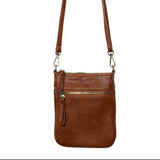 This cognac colored compact phone bag is designed for everyday convenience and hands-free style. This slim crossbody is made from softly tumbled vegan leather with a sleek silhouette, adjustable crossbody strap and a secure zip closure. The Lia features a front zip pocket and a back slide pocket to keep your phone, cards, keys and small essentials neatly organized and easy to access. This crossbody bag is perfect for travel, shopping, concerts or daily errands.
Product Details
Dimensions: 7.5 in. H x 6.25 i