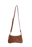 Meet Nicolette, our sleek, curvy cognac colored crossbody pochette with a minimalist style. Featuring soft sculptural curves in tumbled vegan leather, this bag is closed with a brass zipper that encloses 3 interior compartments to keep your cards, cash, keys and phone stowed neatly. The gleaming brass rings open to swap out the two included shoulder straps. A short strap for dressier looks and a longer adjustable crossbody strap when you want to go hands free. Available in an array of beautiful colors, the 