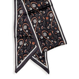 This black paisley design has oranges, purples and whites all over it. Wear it around your neck, use it as a hair tie or, it also is fun tied to your favorite bag!

Approximately 57" L x 5.25" W

100% Polyester