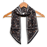 This black paisley design has oranges, purples and whites all over it. Wear it around your neck, use it as a hair tie or, it also is fun tied to your favorite bag!

Approximately 57" L x 5.25" W

100% Polyester