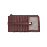 This slim and sleek wallet has nine credit card pockets, each with a snap tab for security and brass-plated hardware. It also has an ID window, zippered change pocket, and zippered billfold pocket in distressed currant vegan leather.


DIMENSIONS: 3.75 IN. H X 7.25 IN. W X .25 IN. D&nbsp;


100% Vegan leather (polyurethane)