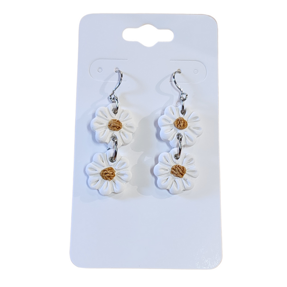 You will love these lightweight, trendy polymer clay earrings with two small white daisies with a yellow center hanging down. This pair of clay earrings is coated with a resin layer to give them a pretty shine and finished look! The earring hooks are comfortable and easy to wear and made of high-quality, strong/durable stainless steel, which is hypoallergenic and nickel-free. * 

This versatile earring design would accompany any outfit, from casual to dressed up! 

Handcrafted in Texas, USA 
