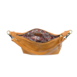 The Danna crossbody is masterfully crafted in our gorgeous new tumbled gloss vegan camel leather to give your look a polished yet casual vibe. Fitted with a top zip closure accented by our signature logo zip pull and two removable and interchangeable shoulder straps; a short shoulder strap to wear snug to the body or a long adjustable, removable crossbody shoulder strap to wear as a crossbody, this slouchy hobo design is perfect for your everyday style.


Dimensions: 9.5 in. H X 10.5 in. W X 3.5 in. D
Top z