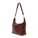 The Danna crossbody is masterfully crafted in our gorgeous new tumbled gloss vegan spicy red leather to give your look a polished yet casual vibe. Fitted with a top zip closure accented by our signature logo zip pull and two removable and interchangeable shoulder straps; a short shoulder strap to wear snug to the body or a long adjustable, removable crossbody shoulder strap to wear as a crossbody, this slouchy hobo design is perfect for your everyday style.


Dimensions: 9.5 in. H X 10.5 in. W X 3.5 in. D
T