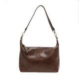 The Danna crossbody is masterfully crafted in our gorgeous new tumbled gloss vegan hickory leather to give your look a polished yet casual vibe. Fitted with a top zip closure accented by our signature logo zip pull and two removable and interchangeable shoulder straps; a short shoulder strap to wear snug to the body or a long adjustable, removable crossbody shoulder strap to wear as a crossbody, this slouchy hobo design is perfect for your everyday style.


Dimensions: 9.5 in. H X 10.5 in. W X 3.5 in. D
Top