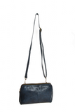 Retro styling crafted in antiqued vegan leather gives this dark indigo clutch a vintage vibe. The removable woven wrist strap is the finishing touch on this stylish bag so you can wear it as a wristlet, a clutch, or a crossbody with the included removable shoulder strap!





6.75"H x 9.75"W x 2.25"D

Removable and adjustable crossbody strap 22"-26"

Removable long wristlet strap 7.5" long

Zippered top closure

Interior zippered pocket

Exterior back zipper pocket

Brass plated hardware

100% vegan leather